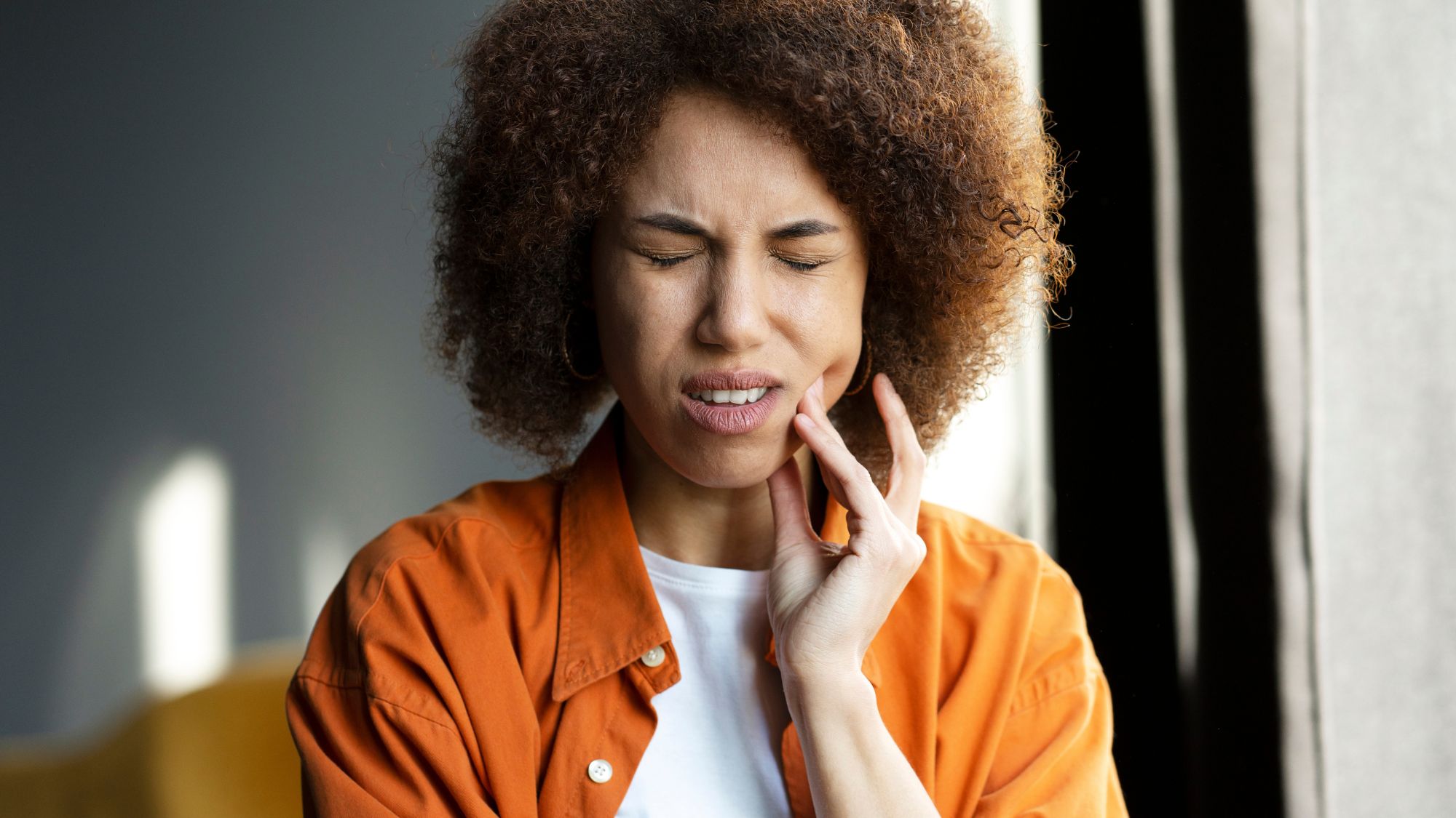 A girl demonstrating the difference between gum bleeding and gum disease