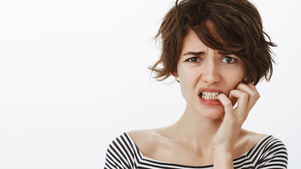A girl showing how stress can cause gum bleeding
