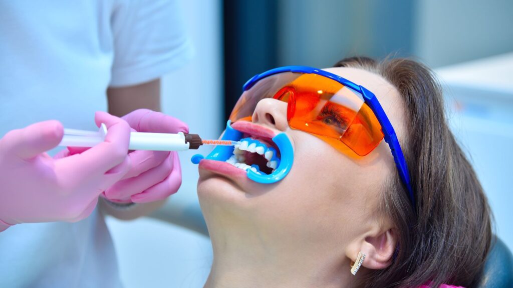 A girl undergoing a teeth whitening process in a dental clinic in Livingston