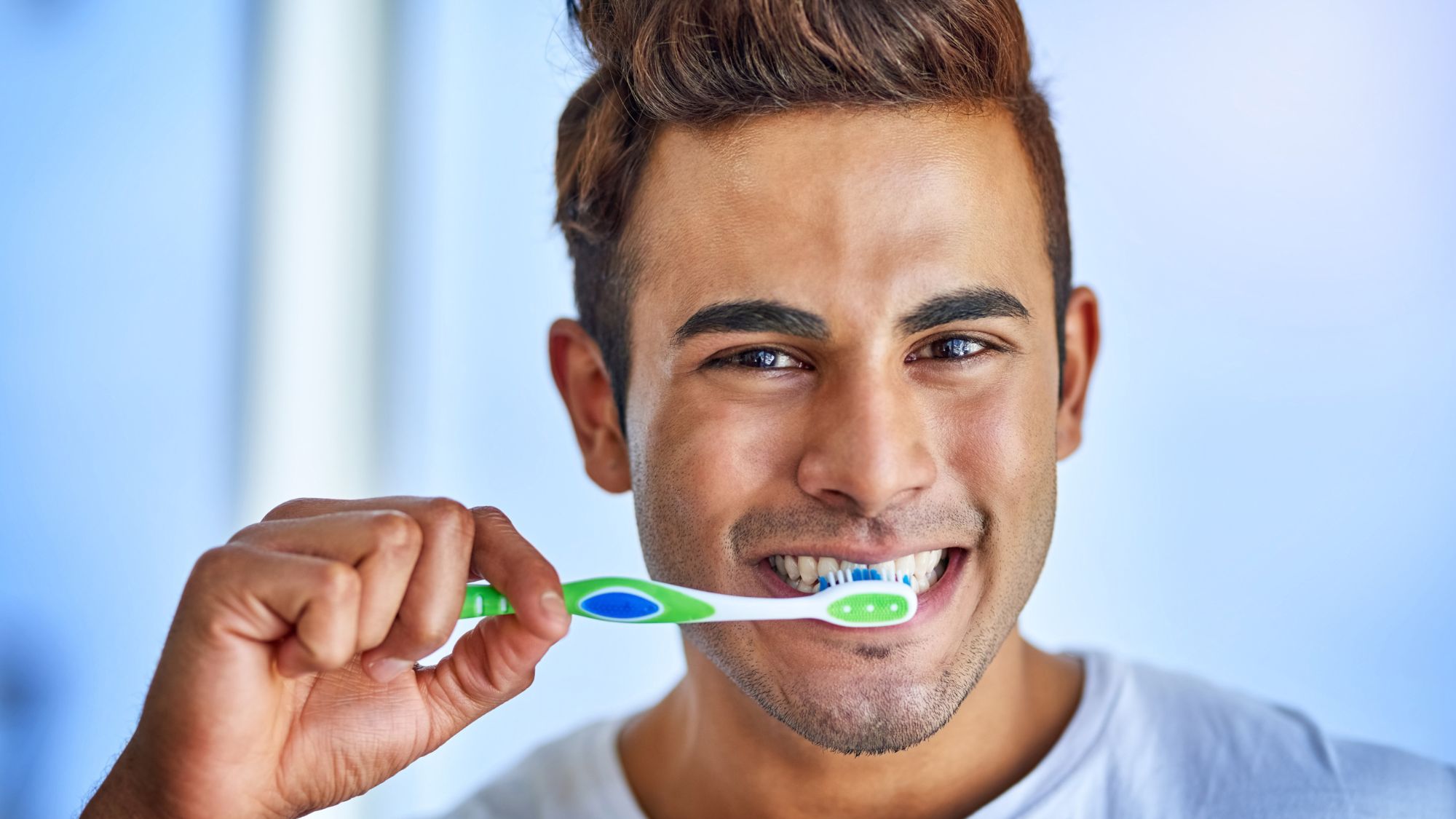 A man applying the best toothbrushing techniques to improve his oral health