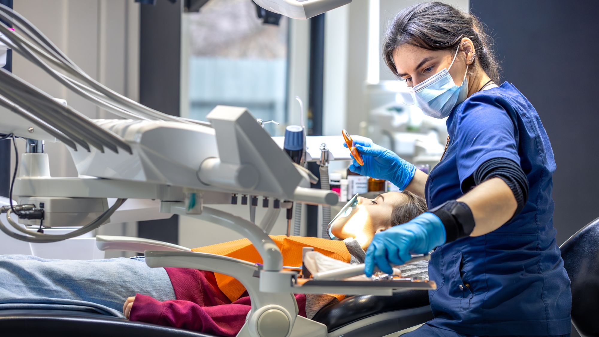 An emergency dentist working in her clinic